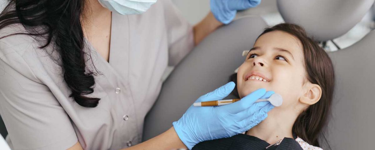 fluoride treatment appliance on a kid by a dentist