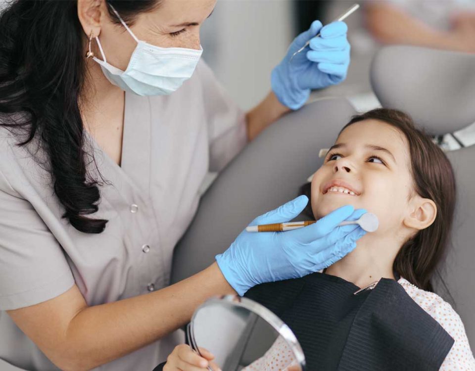 fluoride treatment appliance on a kid by a dentist